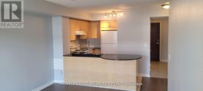 Toronto (Bayview Village) condo for rent - A kitchen area with a counter and cabinets.