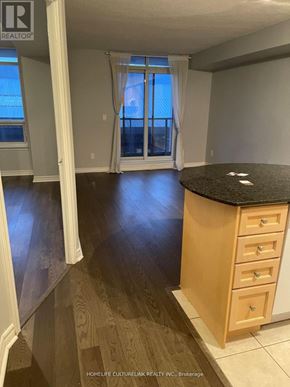 Toronto (Bayview Village) condo for rent - A room with a wooden floor and a black countertop.