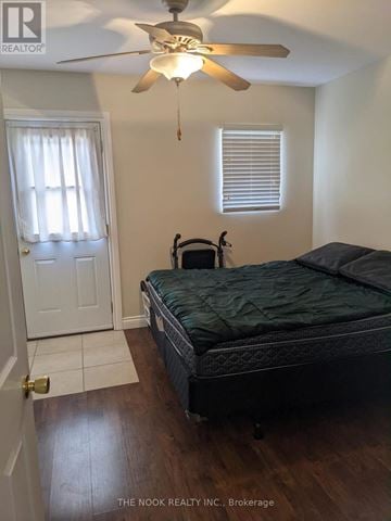 Ajax (Central West) triplex for rent - A bedroom with a bed, ceiling fan, and window with blinds.