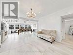 Markham (Unionville) apartment for rent - A large open living room with a couch and a chandelier.