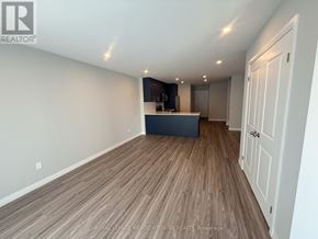 Kitchener townhouse for rent - A room with wooden flooring and a white door.