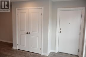 Kitchener townhouse for rent - Two white doors in a room with a brokerage logo.
