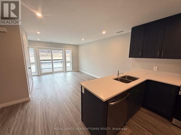 Kitchener townhouse for rent - A kitchen with black cabinets and a white countertop.