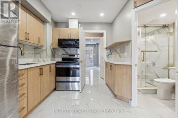 Markham (Middlefield) townhouse for rent - A modern kitchen with wooden cabinets and stainless steel appliances.