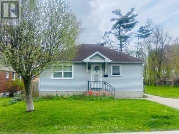 Barrie (Wellington) apartment for rent - A small house with a tree in front of it.