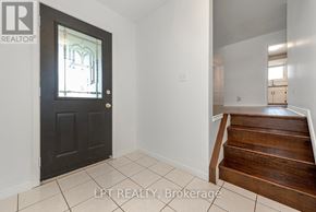Guelph (Victoria North) apartment for rent - A black door with a glass window is in a room with white walls.