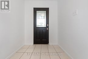 Guelph (Victoria North) apartment for rent - A black door with a glass window is in the middle of a white room.