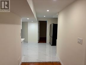 Markham (Milliken Mills East) apartment for rent - A hallway with a refrigerator on the right and a door at the end.