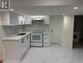 Markham (Milliken Mills East) apartment for rent - A white kitchen with a marble floor and a washing machine in the corner.