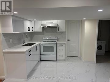 Markham (Milliken Mills East) apartment for rent - A white kitchen with a marble floor and a washing machine in the corner.