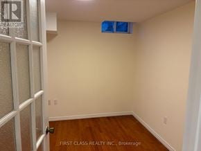 Markham (Milliken Mills East) apartment for rent - A room with wooden flooring and a door on the left.