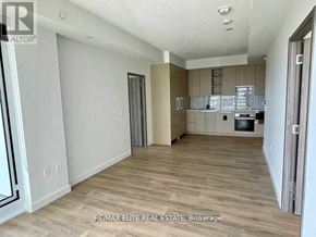 Toronto (Bayview Village) condo for rent - A spacious kitchen with wooden flooring and a dining area.