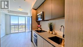 Toronto (Newtonbrook West) condo for rent - A modern kitchen with wooden cabinets and a stainless steel sink.