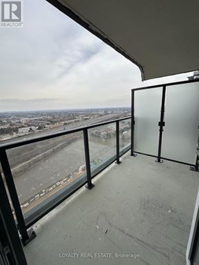 Pickering (Bay Ridges) condo for rent - A balcony with a glass door overlooking a cityscape.