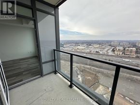 Pickering (Bay Ridges) condo for rent - A balcony with a view of a cityscape and a cloudy sky.