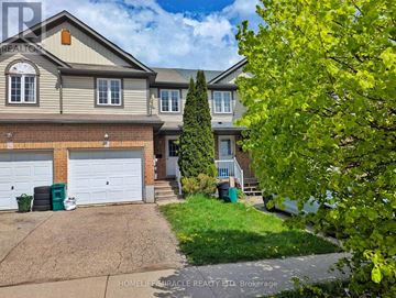 Kitchener townhouse for rent - A large, well-maintained house with a driveway and garage is for sale.