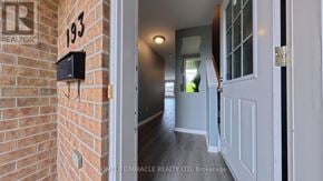 Kitchener townhouse for rent - A well-lit kitchen area with a microwave, oven, and cabinets.