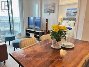 Richmond Hill (Langstaff) condo for rent - A living room with a wooden table and a television on a stand.