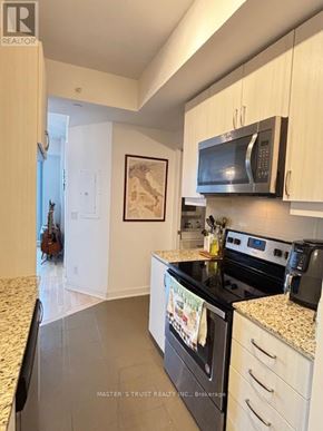 Richmond Hill (Langstaff) condo for rent - A kitchen with a black oven and microwave.
