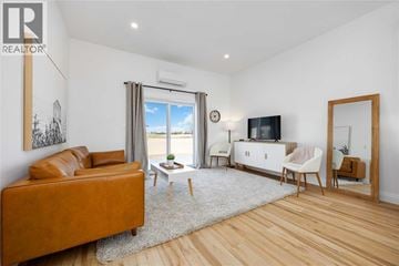 Lambton Shores apartment for rent - A living room with a brown leather sofa and a white cabinet.