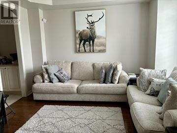 Oakville (Go Glenorchy) townhouse for rent - A living room with a couch and a painting of a deer on the wall.