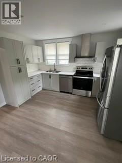 Kitchener apartment for rent - A kitchen with white cabinets and a stainless steel refrigerator.