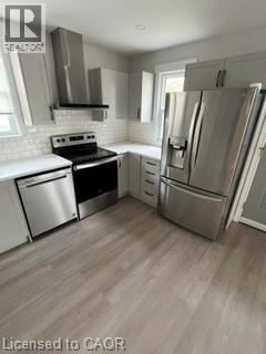Kitchener apartment for rent - A kitchen with a refrigerator, stove, and dishwasher.