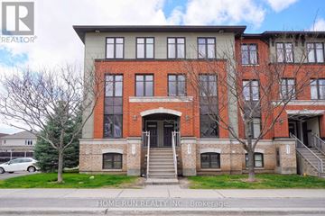 Ottawa townhouse for rent - A building with a red brick facade and a large front door.