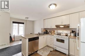 Ottawa townhouse for rent - A kitchen with white appliances and cabinets.