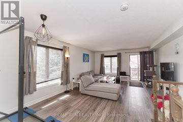 Ottawa townhouse for rent - A living room with a grey couch and a wooden floor.