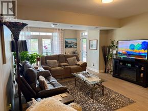 Thorold (Thorold Downtown) apartment for rent - A living room with a brown couch, a coffee table, and a flat screen TV.