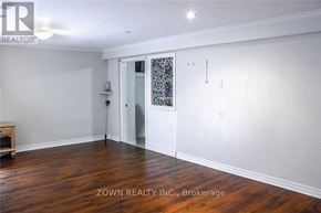 Toronto (Parkwoods-Donalda) duplex for rent - A room with wood flooring and a white door with a glass panel.