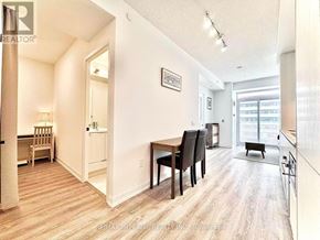 Vaughan (Vaughan Corporate Centre) condo for rent - A well-lit apartment with a dining area and a kitchen in the background.