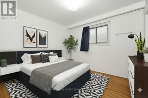 Toronto (Glenfield-Jane Heights) apartment for rent - A bedroom with a bed, nightstand, and a plant.