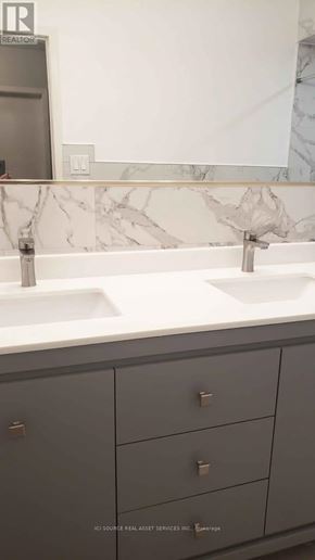 Toronto (Glenfield-Jane Heights) apartment for rent - A bathroom sink with a marble counter top and grey cabinets.