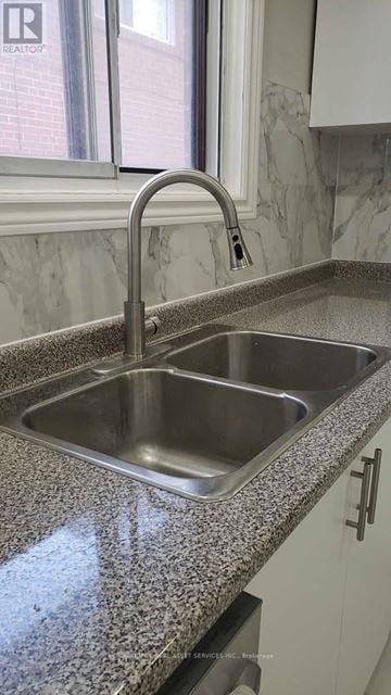 Toronto (Glenfield-Jane Heights) apartment for rent - A kitchen sink with a granite countertop and a chrome faucet.