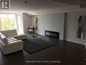 Milton (Cl Clarke) condo for rent - A living room with a white sofa and a glass coffee table.