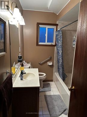 Windsor apartment for rent - A bathroom with a brown door and a white sink.