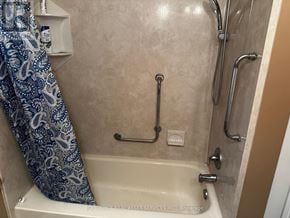 Windsor apartment for rent - A bathroom with a shower curtain and a bathtub.