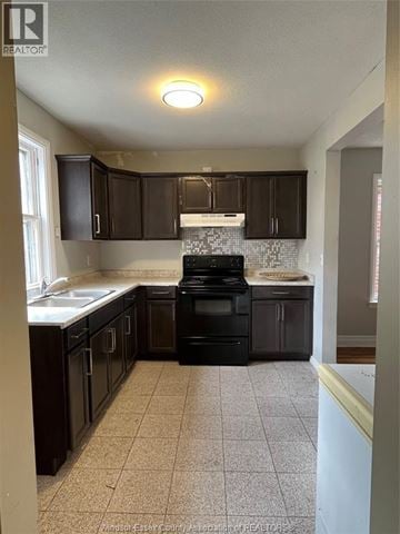 Windsor apartment for rent - A kitchen with black cabinets and a black stove top oven.