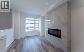 Paris townhouse for rent - A living room with a fireplace and a large window.