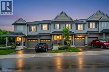 Waterloo townhouse for rent - A large, modern house with a realtor logo in the corner.