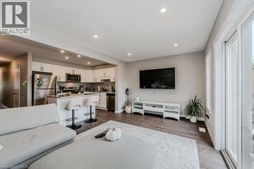 Waterloo townhouse for rent - A modern living room with a grey sofa and a television on the wall.