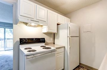Richland apartment for rent - A white kitchen with a stove and refrigerator.