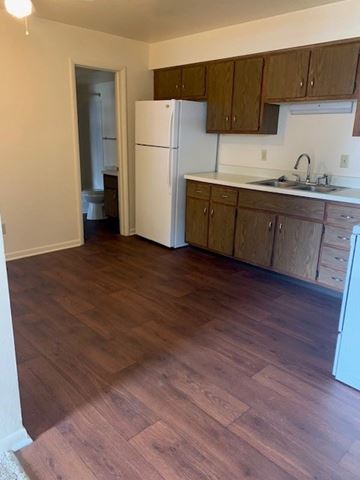 Richland apartment for rent - A kitchen with wooden floors and white appliances.