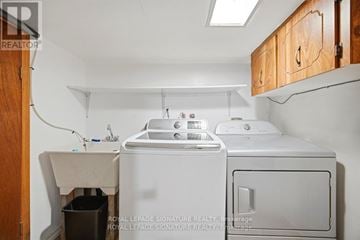 Toronto (Caledonia-Fairbank) apartment for rent - A small laundry room with a washer and dryer.