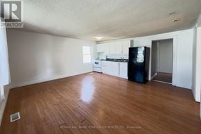Barrie (Allandale Centre) apartment for rent - A room with a wooden floor and a refrigerator.