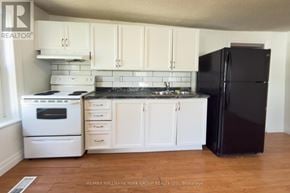 Barrie (Allandale Centre) apartment for rent - A kitchen with white appliances and cabinets.
