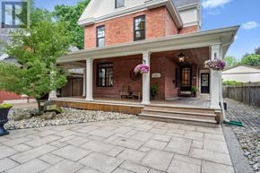 Oakville (Sw Southwest) apartment for rent - A brick house with a porch and a front yard.