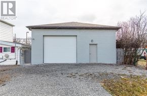 Hamilton (Stoney Creek Industrial) apartment for rent - A gravel driveway leads to a white garage with a grey roof.